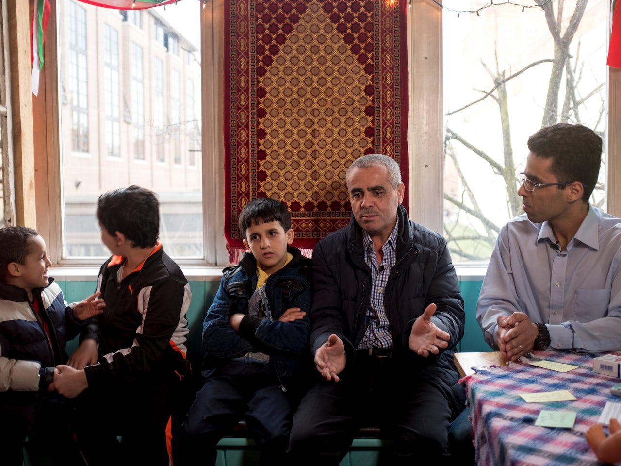 Mohammed Alghutani, center, a refugee from Syria, with his sons Moustafa, 5, Haroon, 12, and Ahmed, 10. Amer Alfayadh, a translator from Iraq, sits on the right.