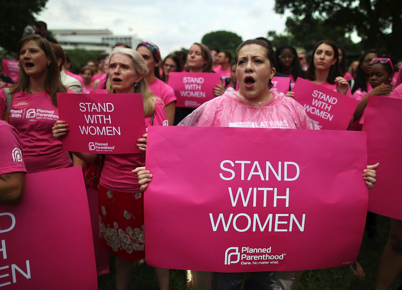Women hold up signs during a women's pro-choice rally on Capitol Hill, July 11, 2013, in Washington, D.C.