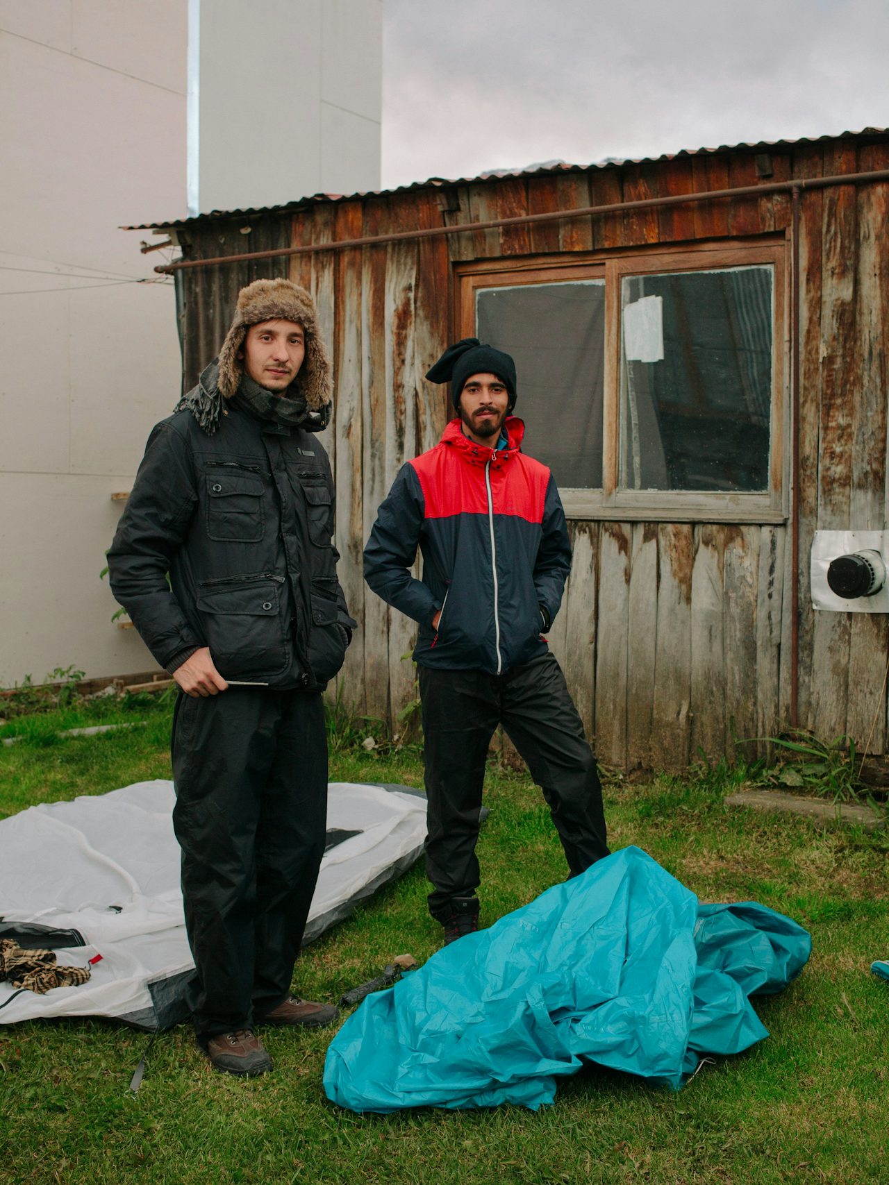 Ivan and Joao, two backpackers from Brazil setting up a tent in a private garden. Due to the cost of accommodations in Ushuaia, many turn to alternative ways of traveling.