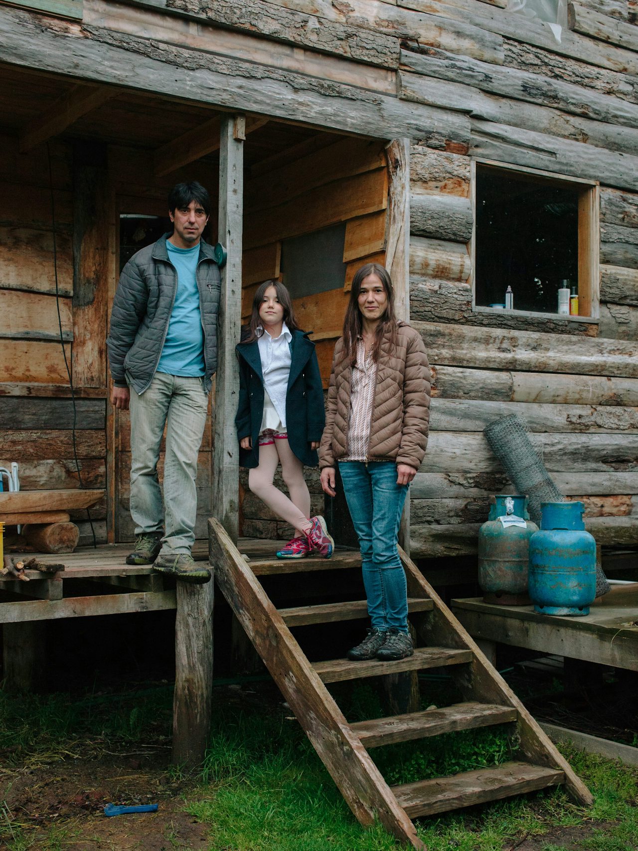 Cali, Veronica, and their daughter Morena in front of their home in Las Raìces.