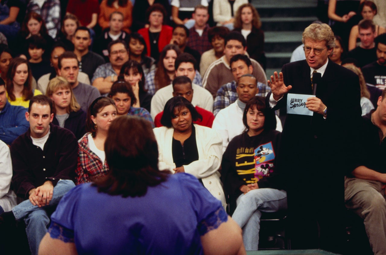 Jerry Springer talks to a guest on his show. The day's topic was 'I Am A Slave To My 600 lb. Wife.'