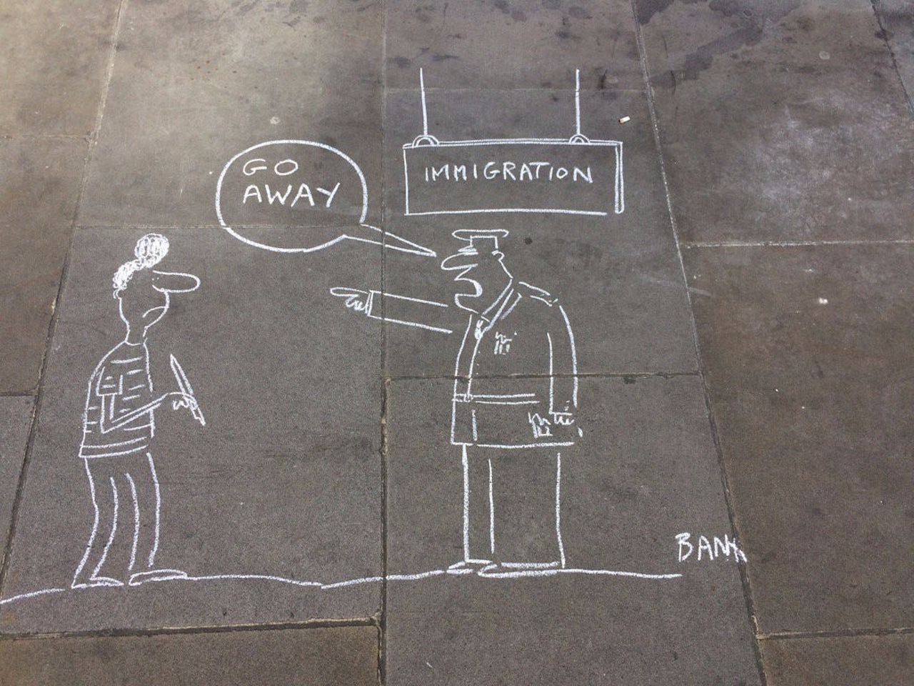 A cartoon drawn on the sidewalk outside the Australian embassy in London in support of the refugee cartoonist known as Eaten Fish.