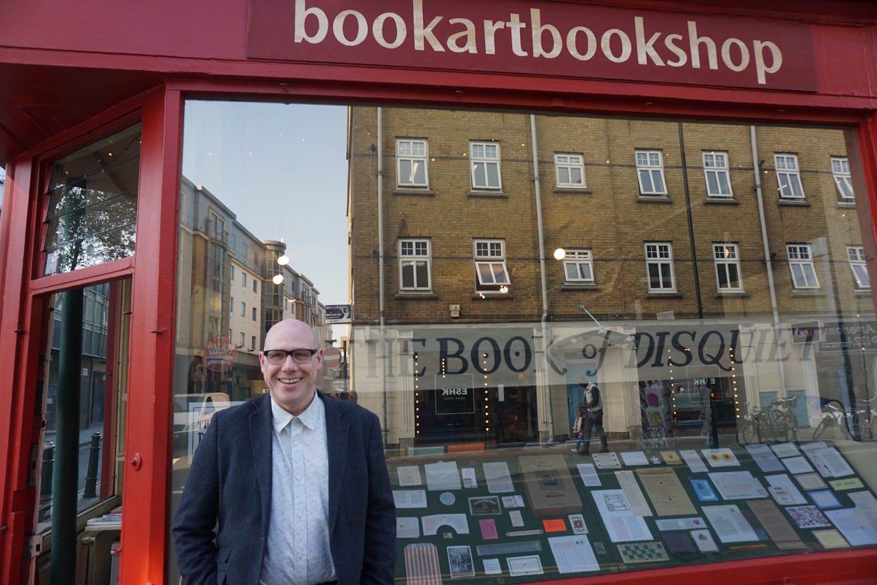 Tim Hopkins in front of his “Book of Disquiet” exhibition.
