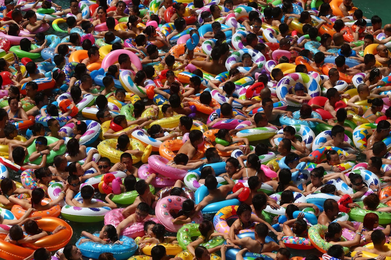People in innertubes swimming at a waterpark in Suining, China.