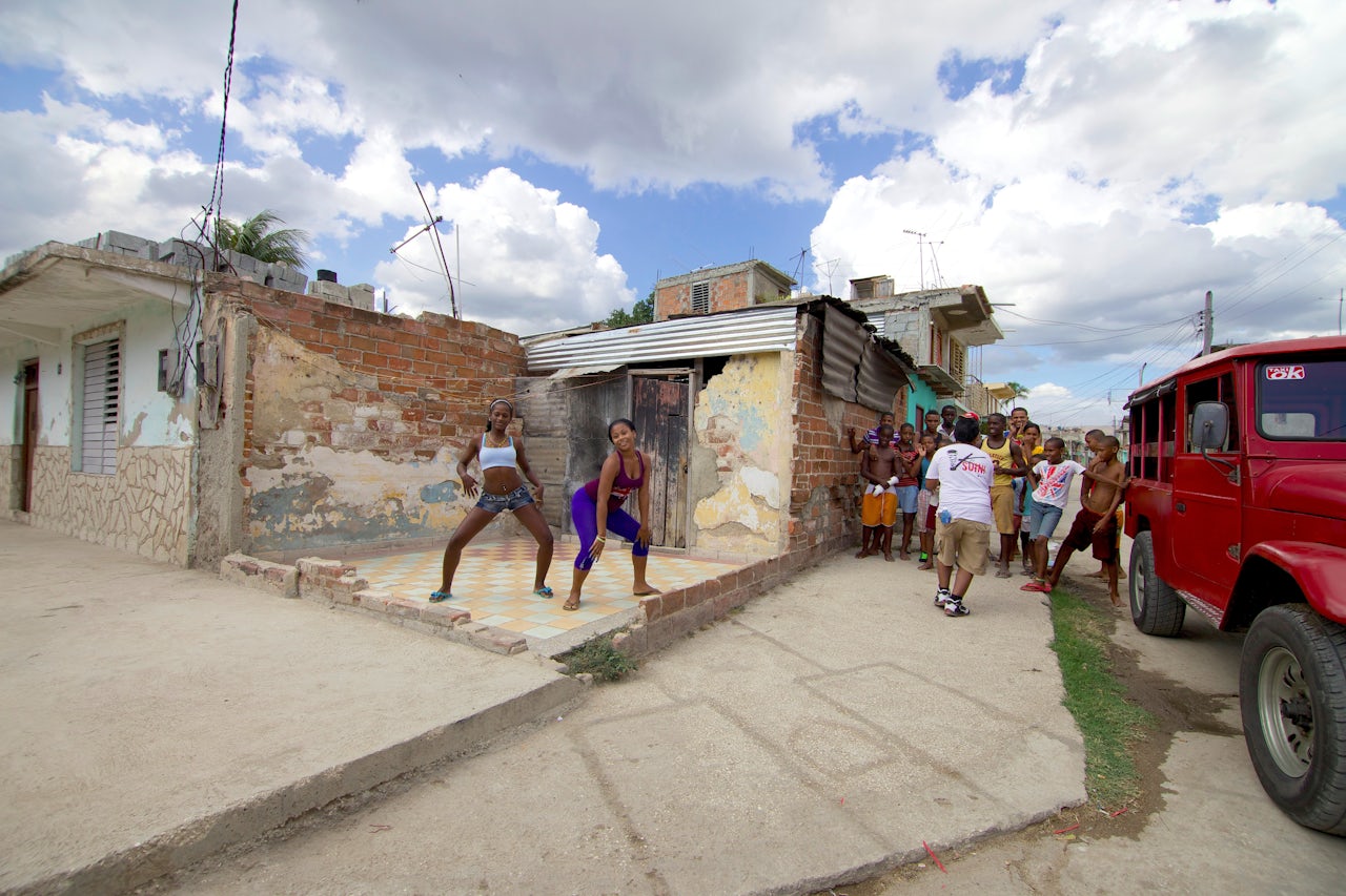 Young women dance in the streets of Santiago de Cuba.