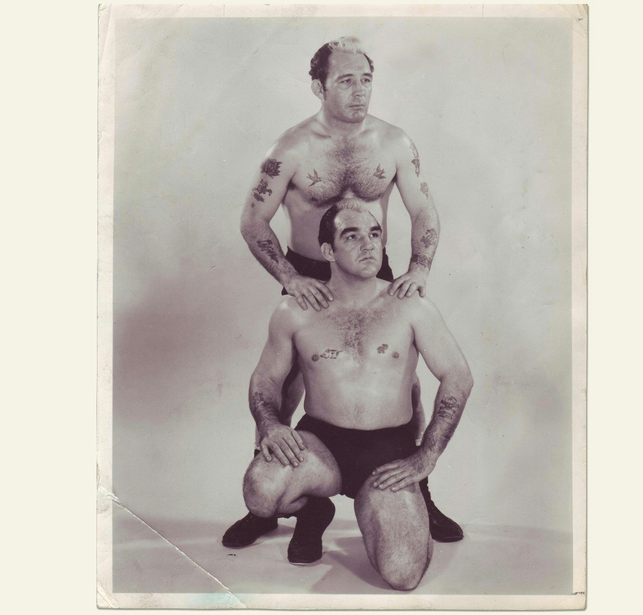 Monroe pioneered tag team wrestling in the American South. Here, he kneels in front of one-time partner Bill Fletcher.