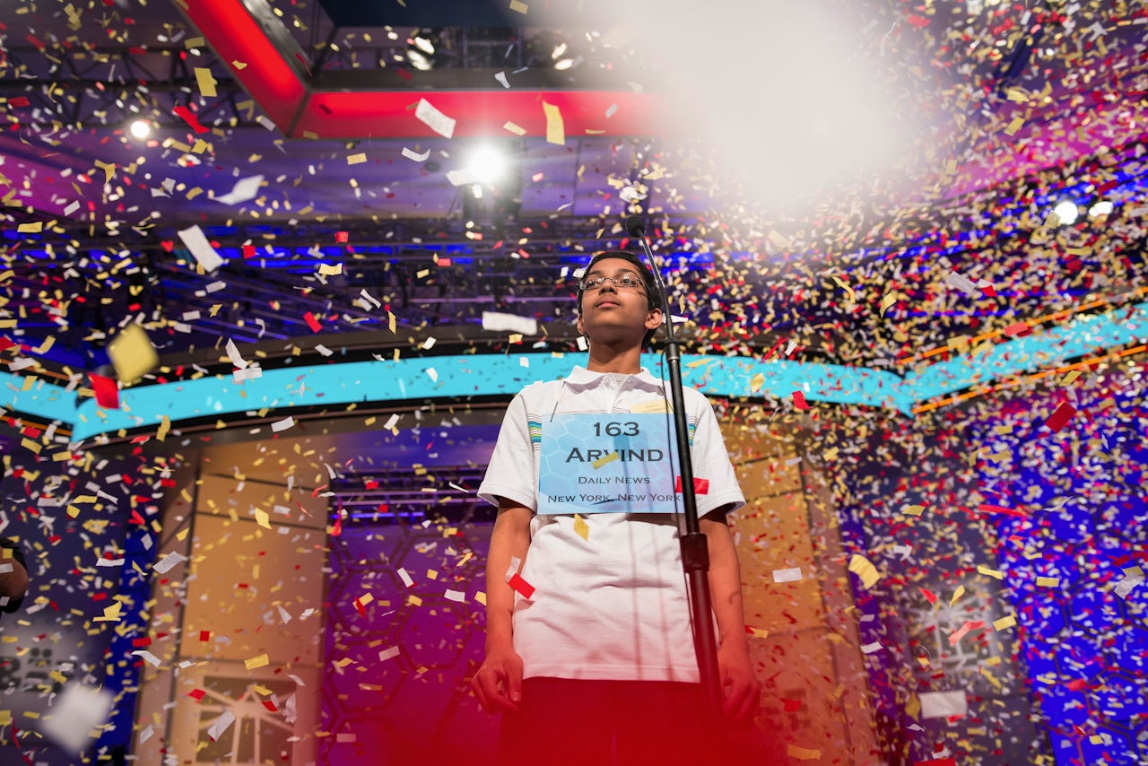 Arvind V. Mahankali stands in falling confetti after winning the 2013 Scripps National Spelling Bee.