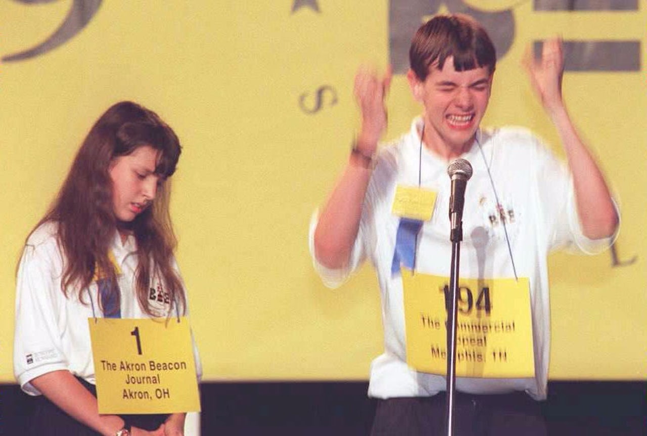 Justin Carroll (R) celebrates winning the Scripps Howard National Spelling Bee over competitor Marjory Lazery. Carroll's winning words were 'Hirumvine' and 'Xanthosis'.