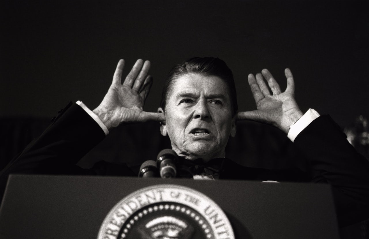 President Ronald Reagan addressing the White House News Photographers Association. President Reagan said, “I've been told this is all off the record and the cameras are off and I've been waiting years to do this.”