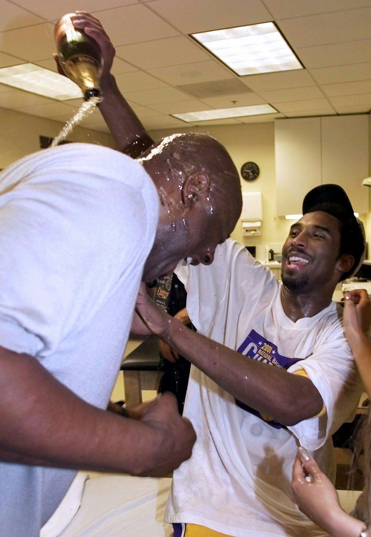 From left: Shaquille O’Neal receives a champagne bath from Kobe Bryant after clinching the 2000 NBA Championship.
