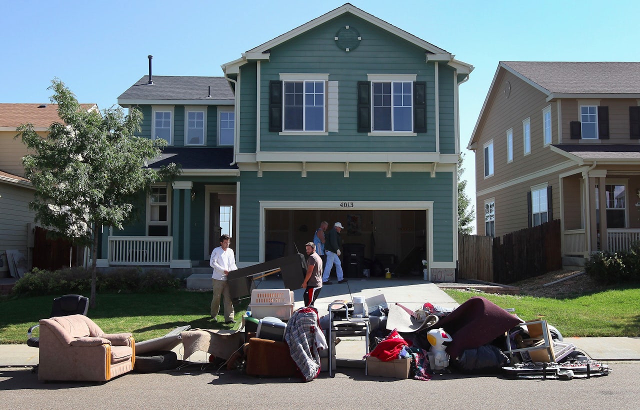 An eviction team moves furniture from a home to the curb during a 2011 foreclosure in Longmont, Colorado.