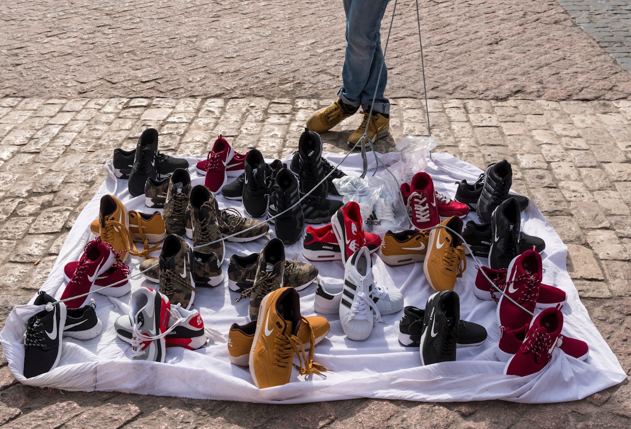 A vendor in Madrid sells counterfeit Nike shoes.
