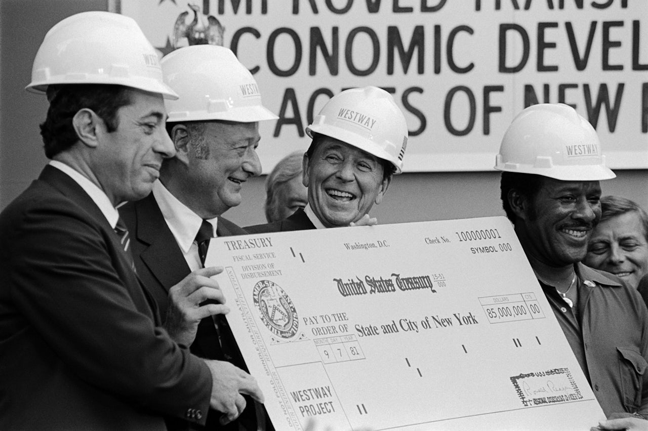 Ronald Reagan presents then New York Governor Mario Cuomo and NYC Mayor Ed Koch with a giant, $85 million check in 1981.
