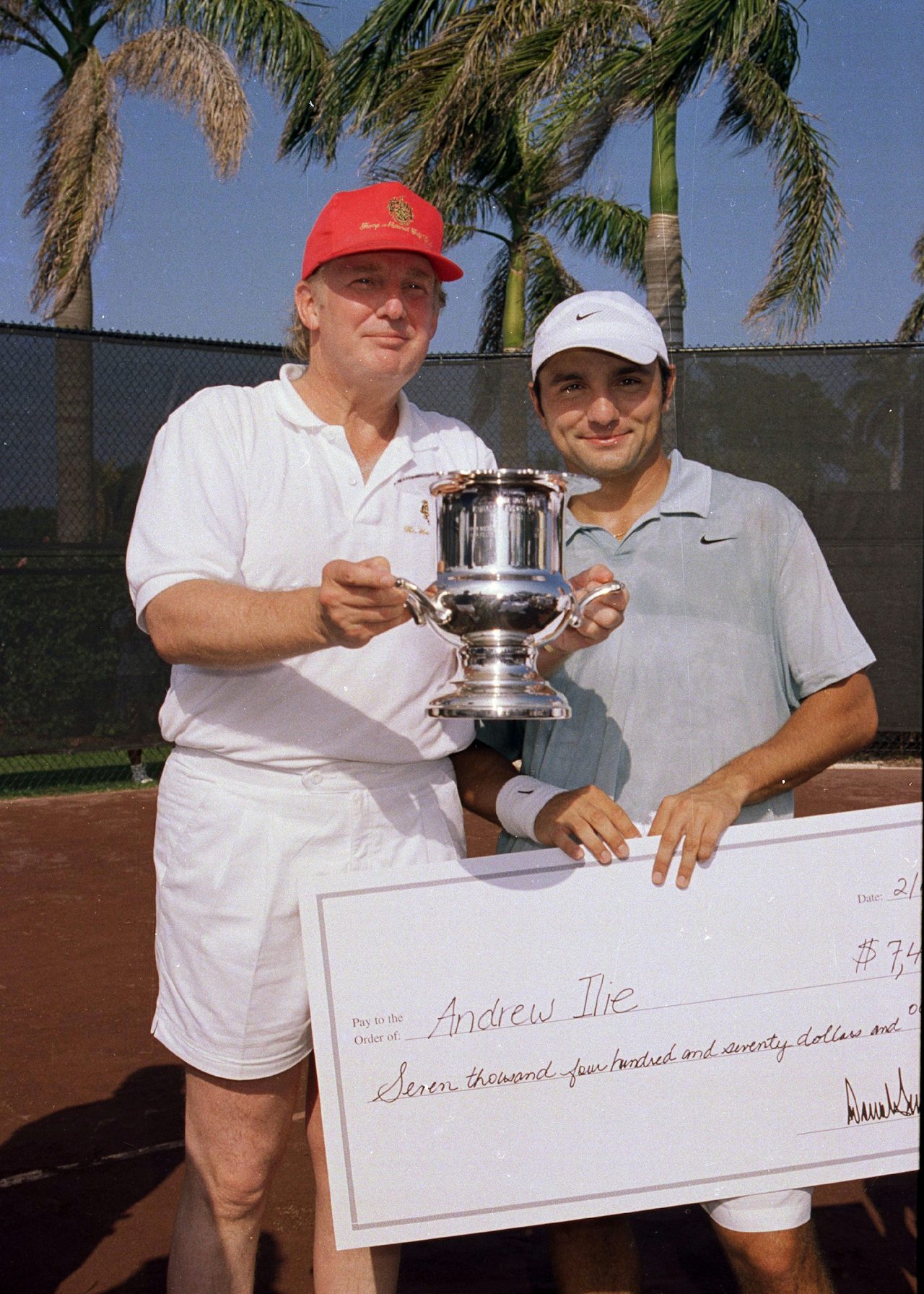 Donald Trump and tennis player Andrew Ilie pose with a giant check at Mar-A-Lago in 2000.