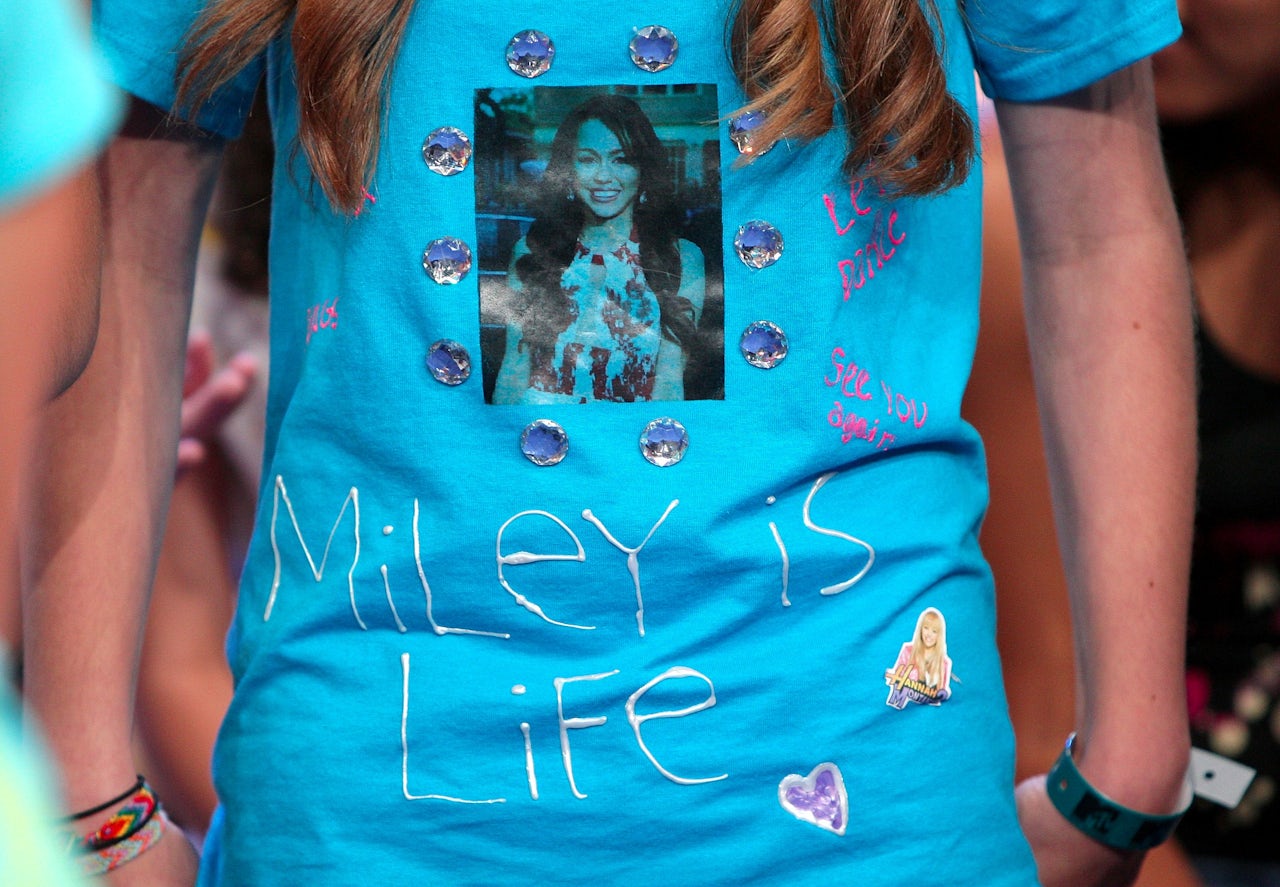 A fan wears a homemade Miley Cyrus t-shirt during the singer's appearance on MTV's TRL in 2008.