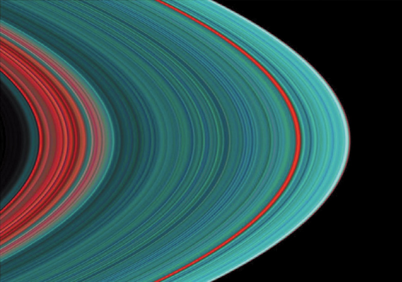 An ultraviolet image of Saturn's rings. Ringlets shown in turquoise have a greater concentration of frozen water than those shown in red.