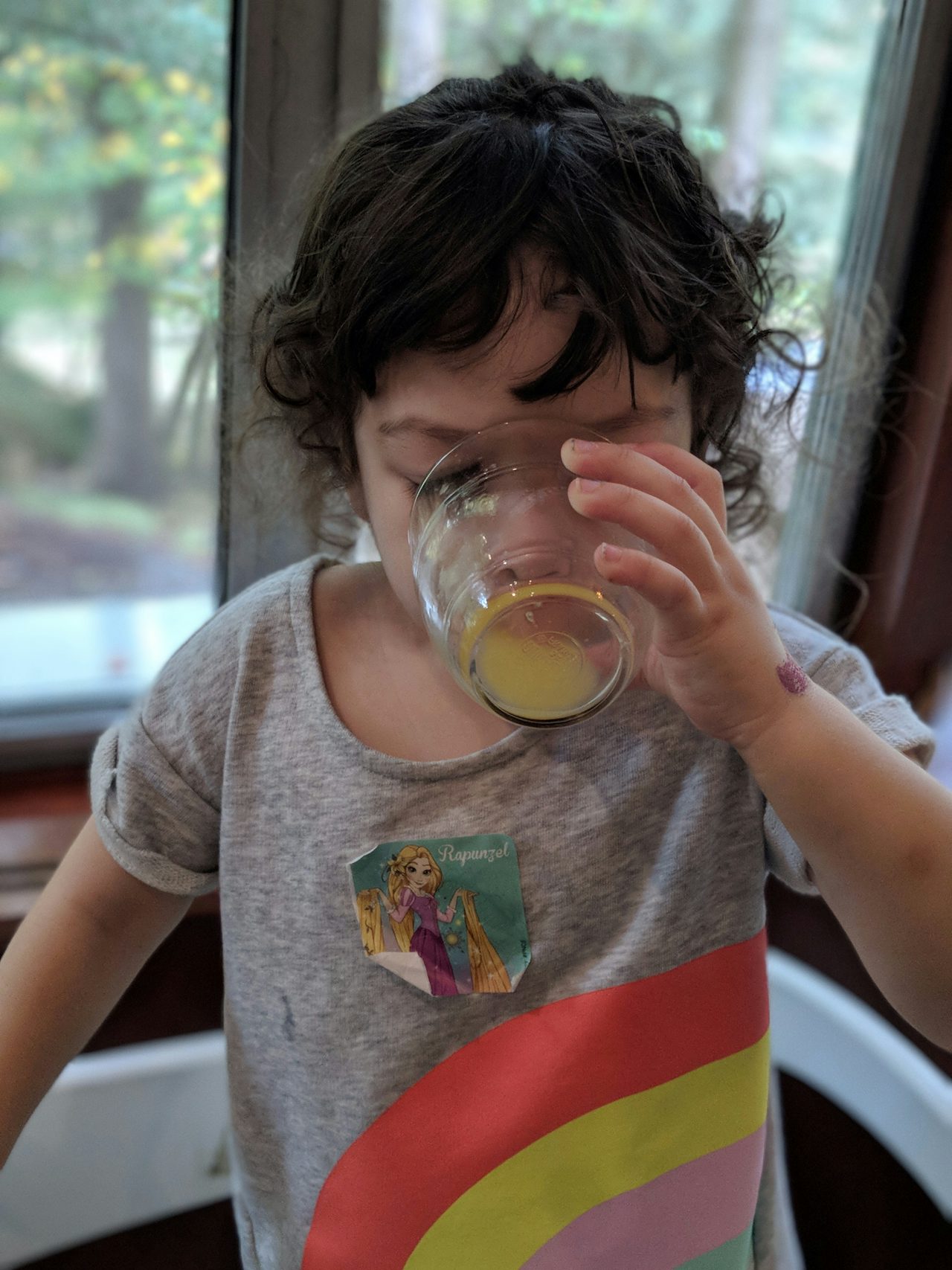 A picture of Zelda chugging orange juice, shot in portrait mode on the Pixel 2 XL.