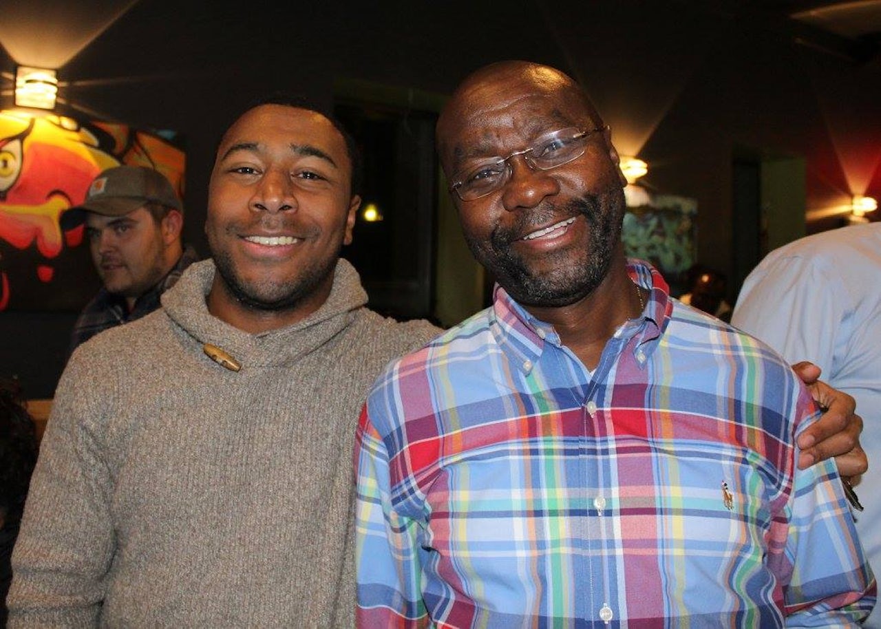Wilmot Collins with his son on the night of his historic win.