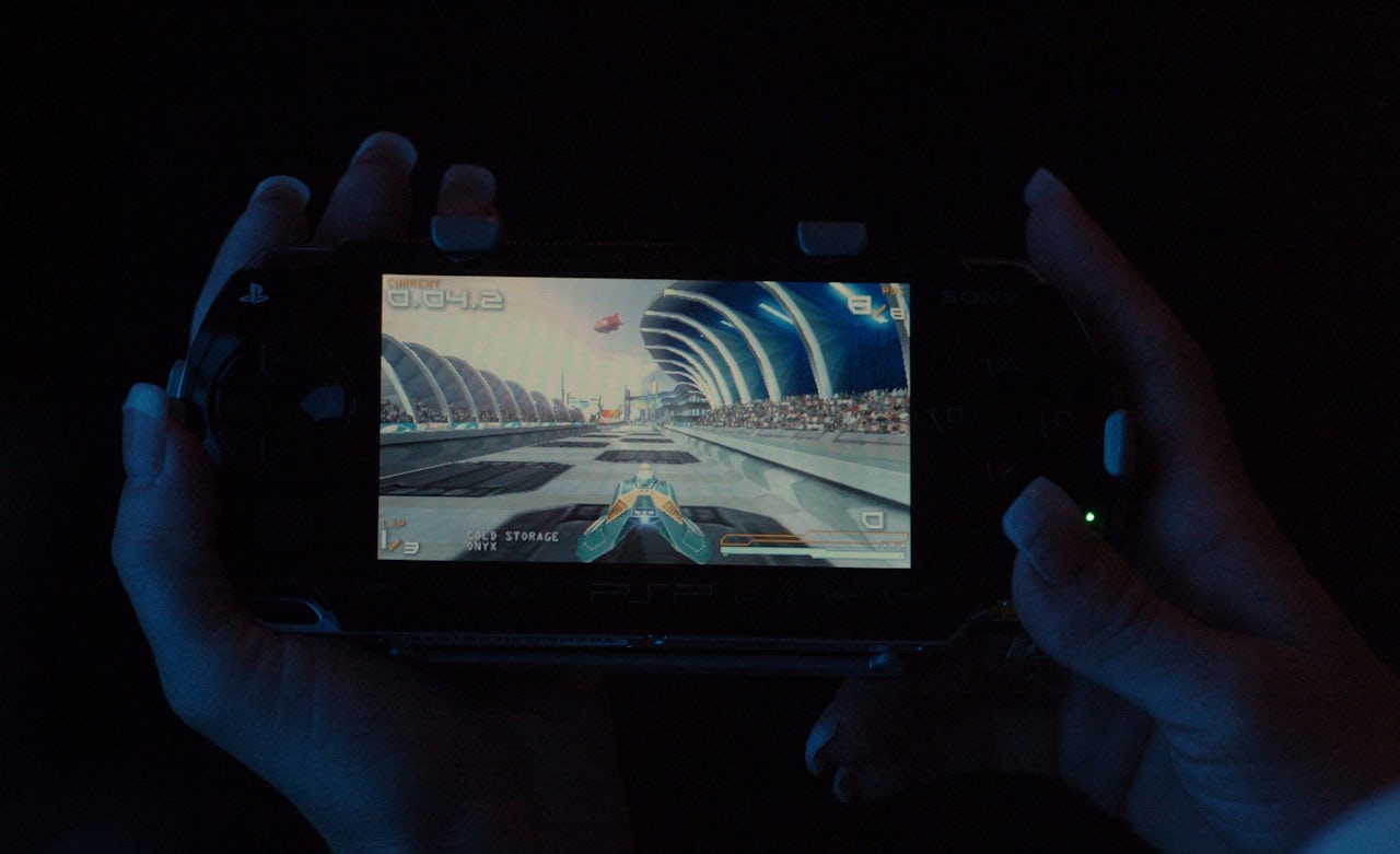 A shot of a racing game on the Sony PSP after its release in 2005. The screen was large, but the graphics in the games were more detailed and the perspective was zoomed out, making it harder for some vision-impaired players to see.