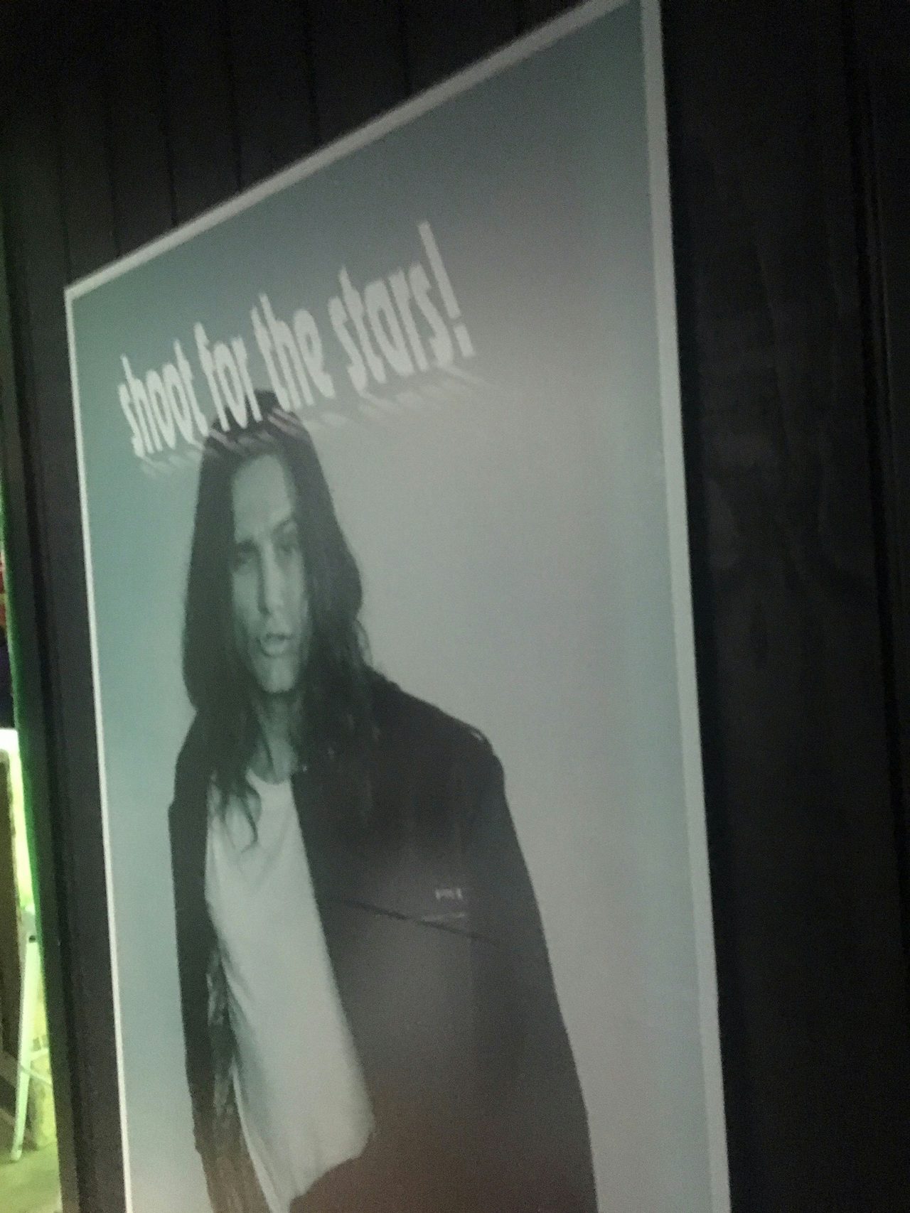 A poster of James Franco hanging in Tommy's Planet.