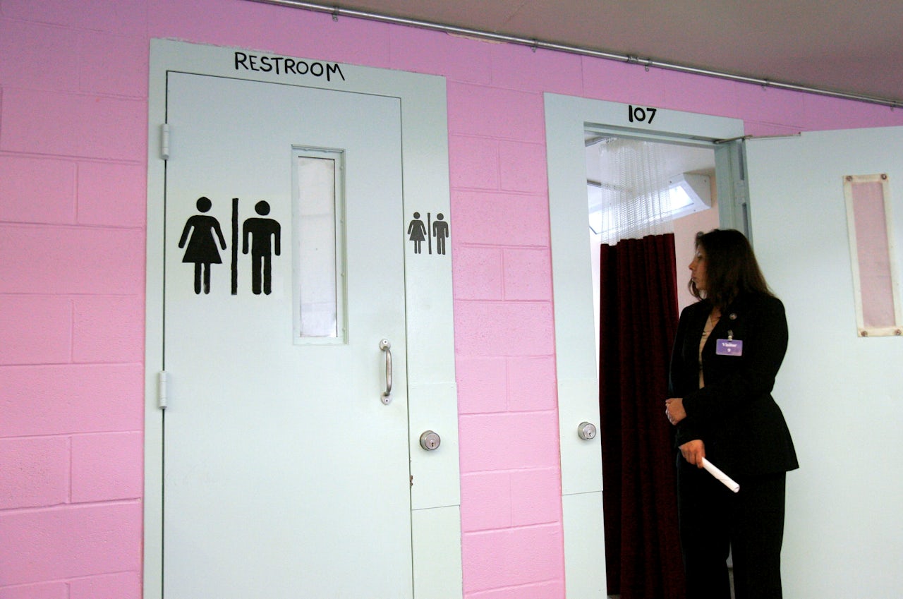Immigration Agent Cynthia Guerra looks into a sleeping area at the T. Don Hutto Residential Center in Taylor, Texas, during a tour for the media.