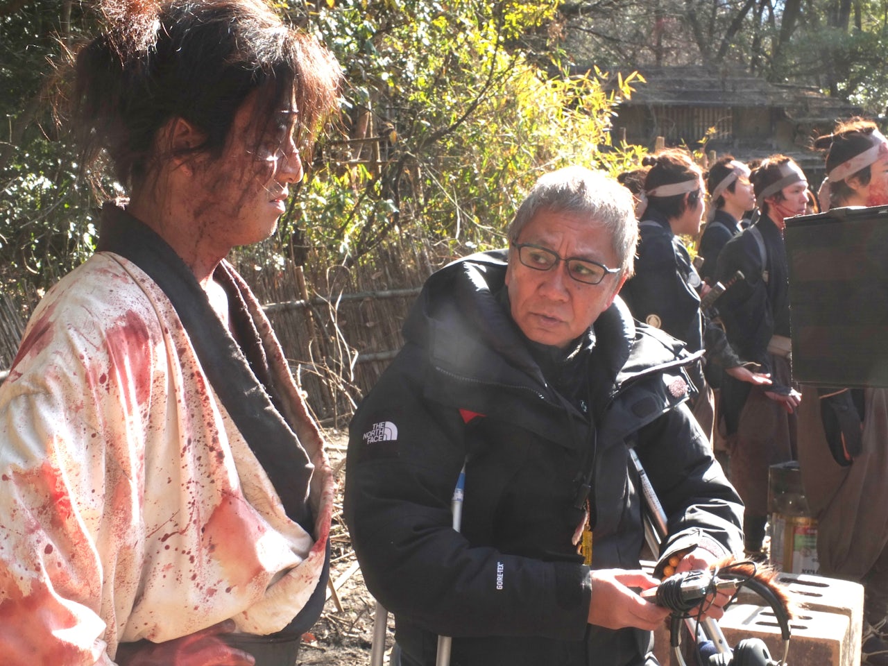 Takashi Miike speaks with lead actor Takuya Kimura (Manji) on the set of Blade of the Immortal.