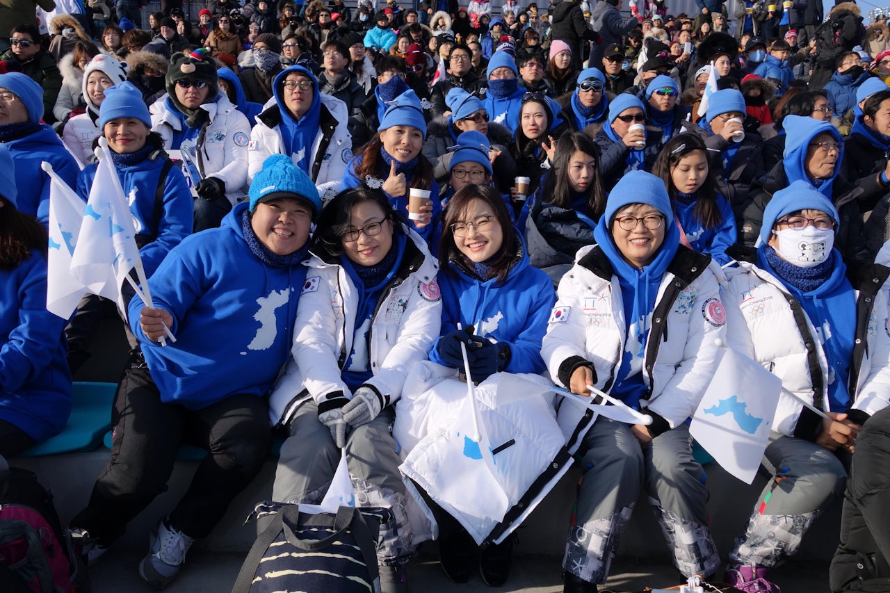 Fans with united Korea flags.