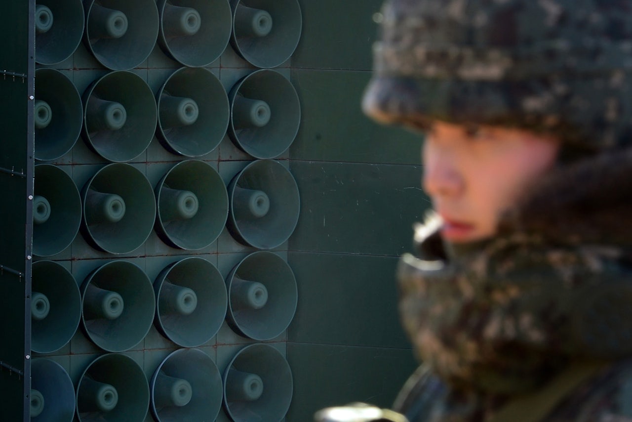 A South Korean solider stands next to the speakers at the DMZ.