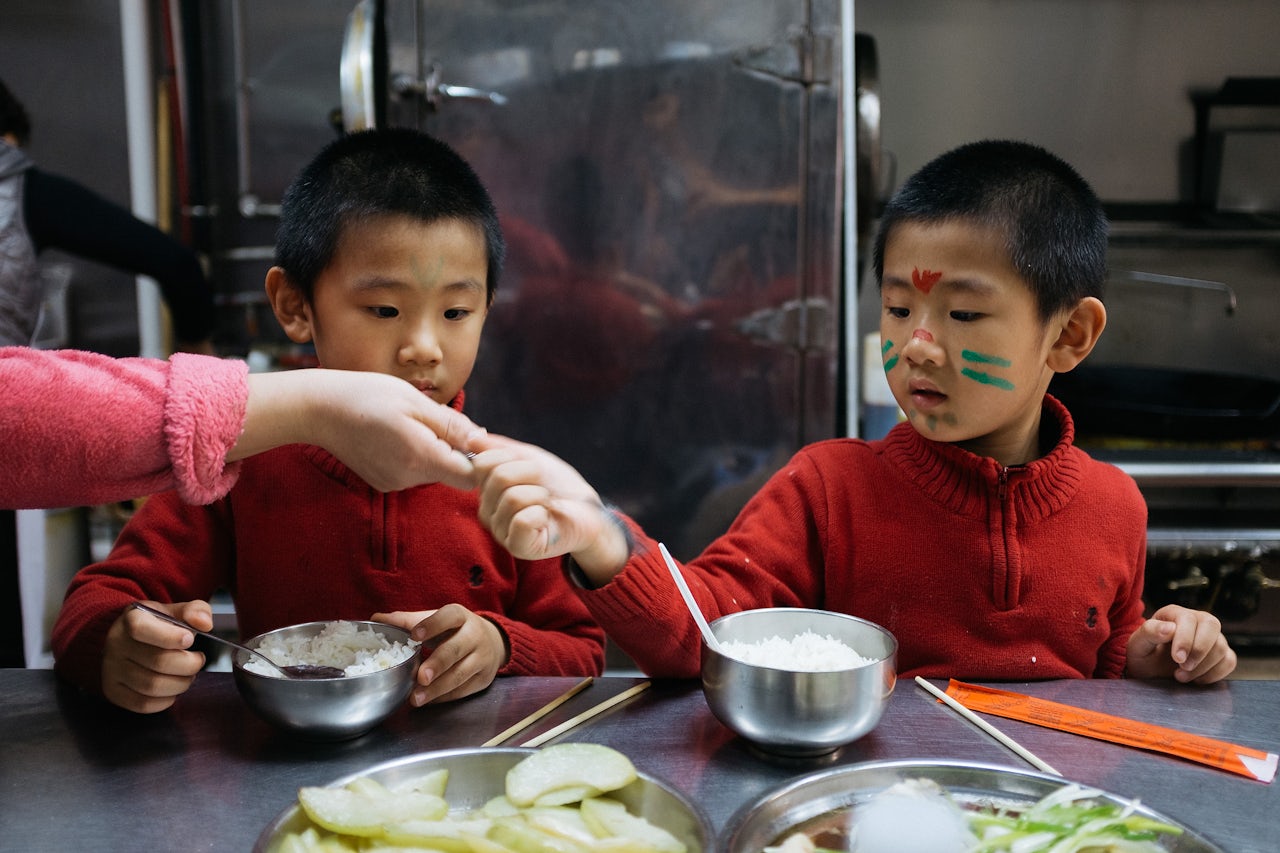 Instead of eating the food they serve to customers, the mother prepares vegetables and fish for her kids to eat.