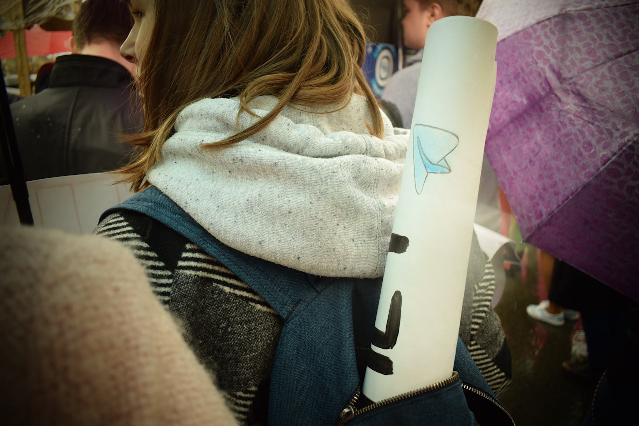 Protester with a poster featuring the Telegram logo