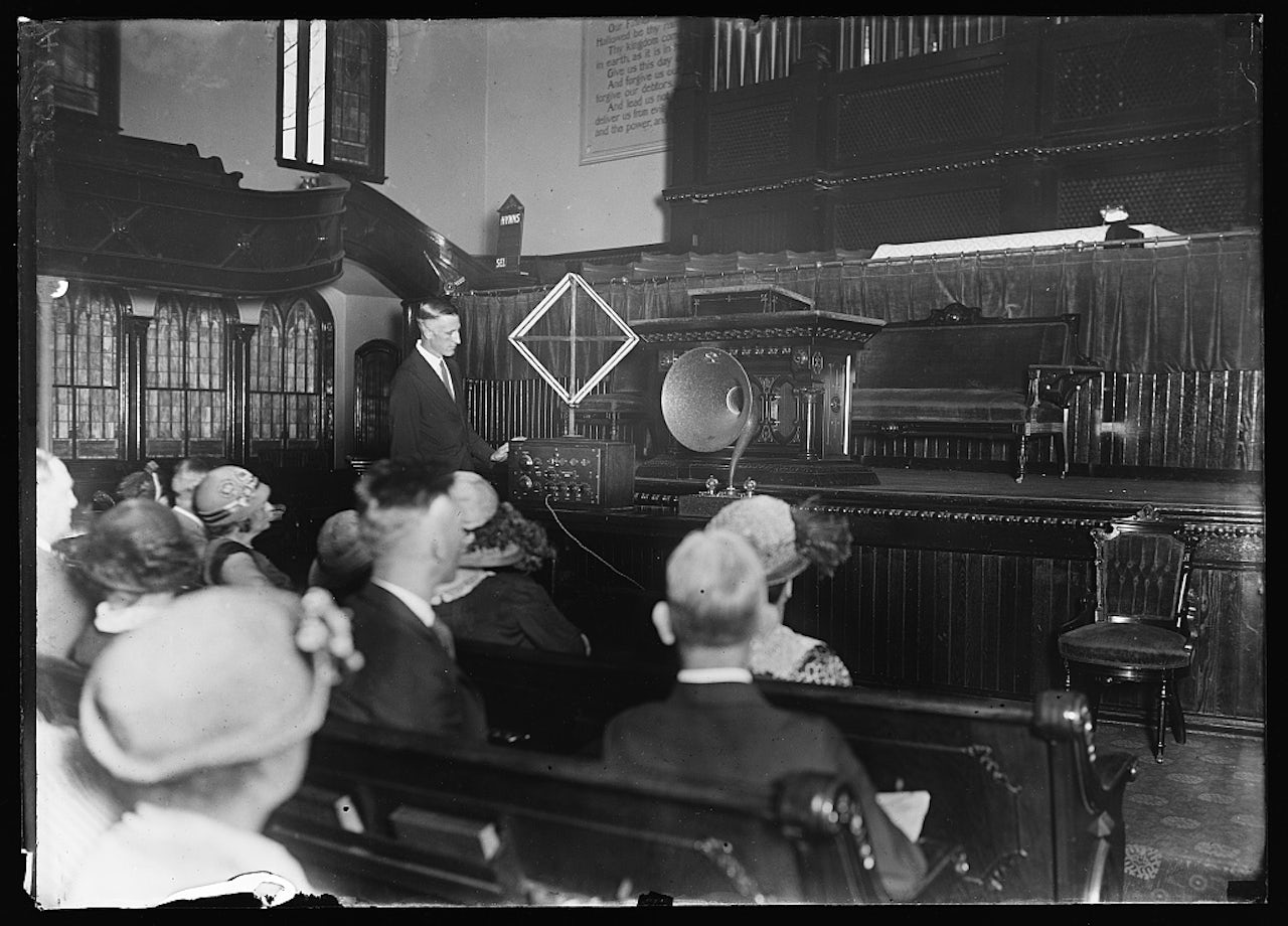 A 1924 photograph shows a man demonstrating an unidentified gadget.