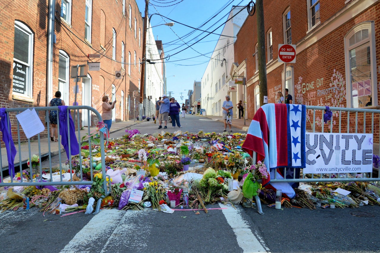 Flowers and notes on the Charlottesville street where Heather Heyer lost her life after a car drove into a crowd full of demonstrators. 2017.