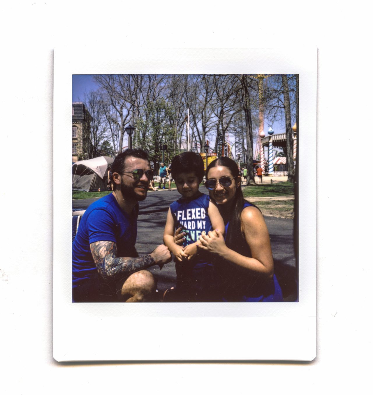 The man and young boy who shared a moment in the Decompression Tent pose for a photo with a young woman in the Fantasy Forest area of the park.