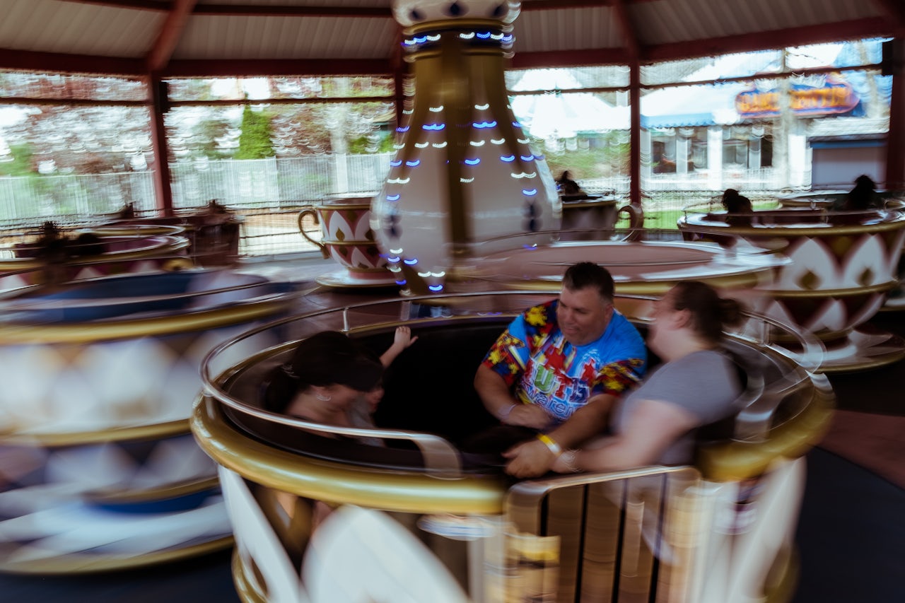 Families whirl around together on the Enchanted Teacups ride, located in the Fantasy Forest area of the park.