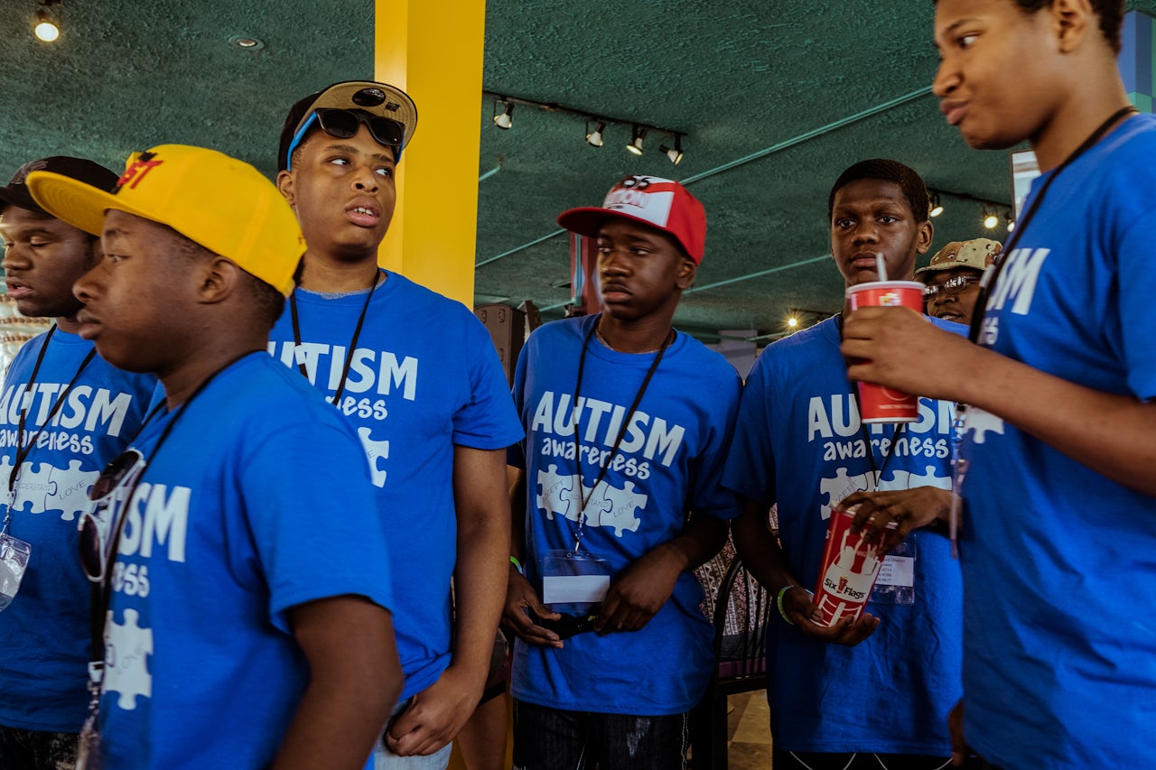 A group of young, teenage boys, who came to Autism Day together, walk through the Yum Yum Cafe.