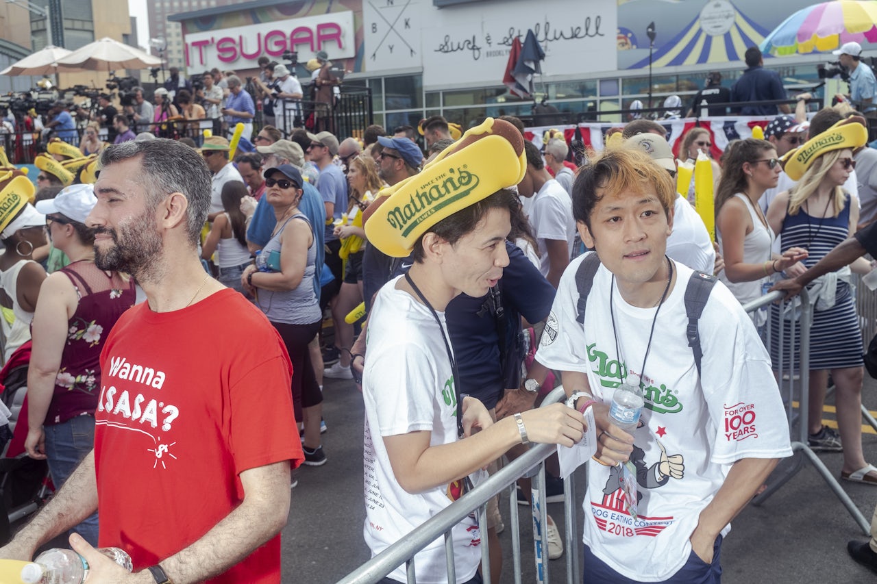 Max Suzuki speaks with his manager at the Nathan’s contest.