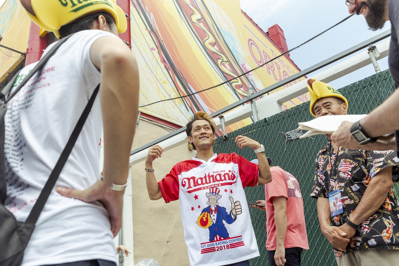 Max Suzuki signs autographs at the Nathan’s hot dog eating contest.