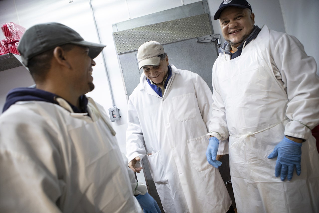 Victor (center) and other Met Food butchers sharing a laugh.