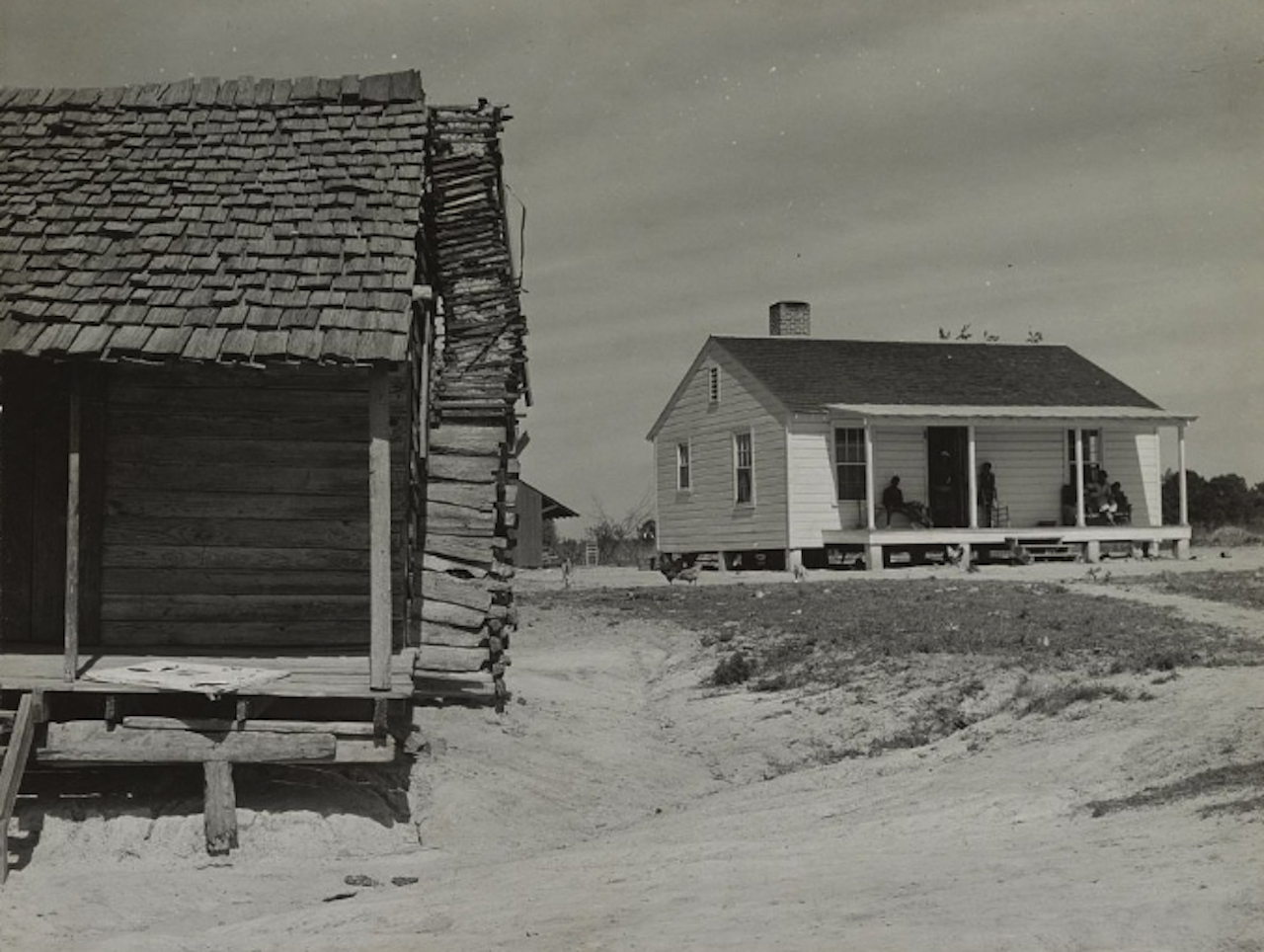 The contrast between the cabin, at left, and the new “Roosevelt House,” at right, was documented in 1939, two years after the federally funded Resettlement Program began.