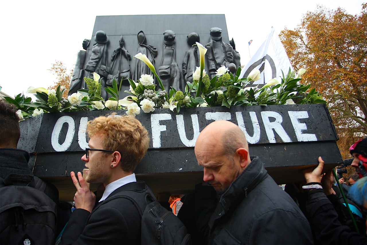 Extinction Rebellion protesters carrying a coffin.