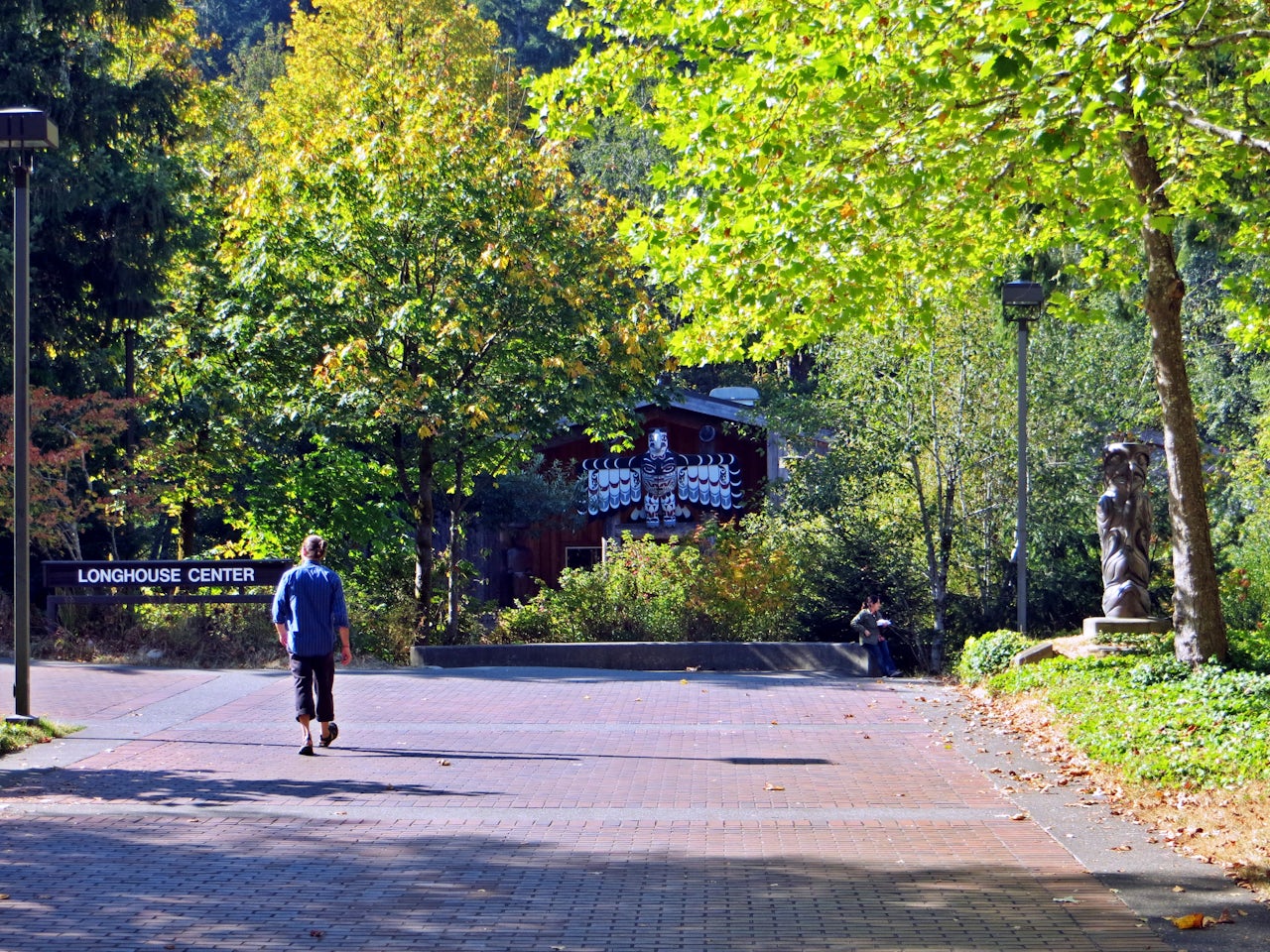A student walks towards the Longhouse Education and Cultural Center, an indigenous arts space on the Evergreen State campus.