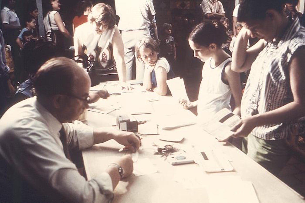 Archival image of children preparing to receive the measles, mumps, and rubella vaccine.