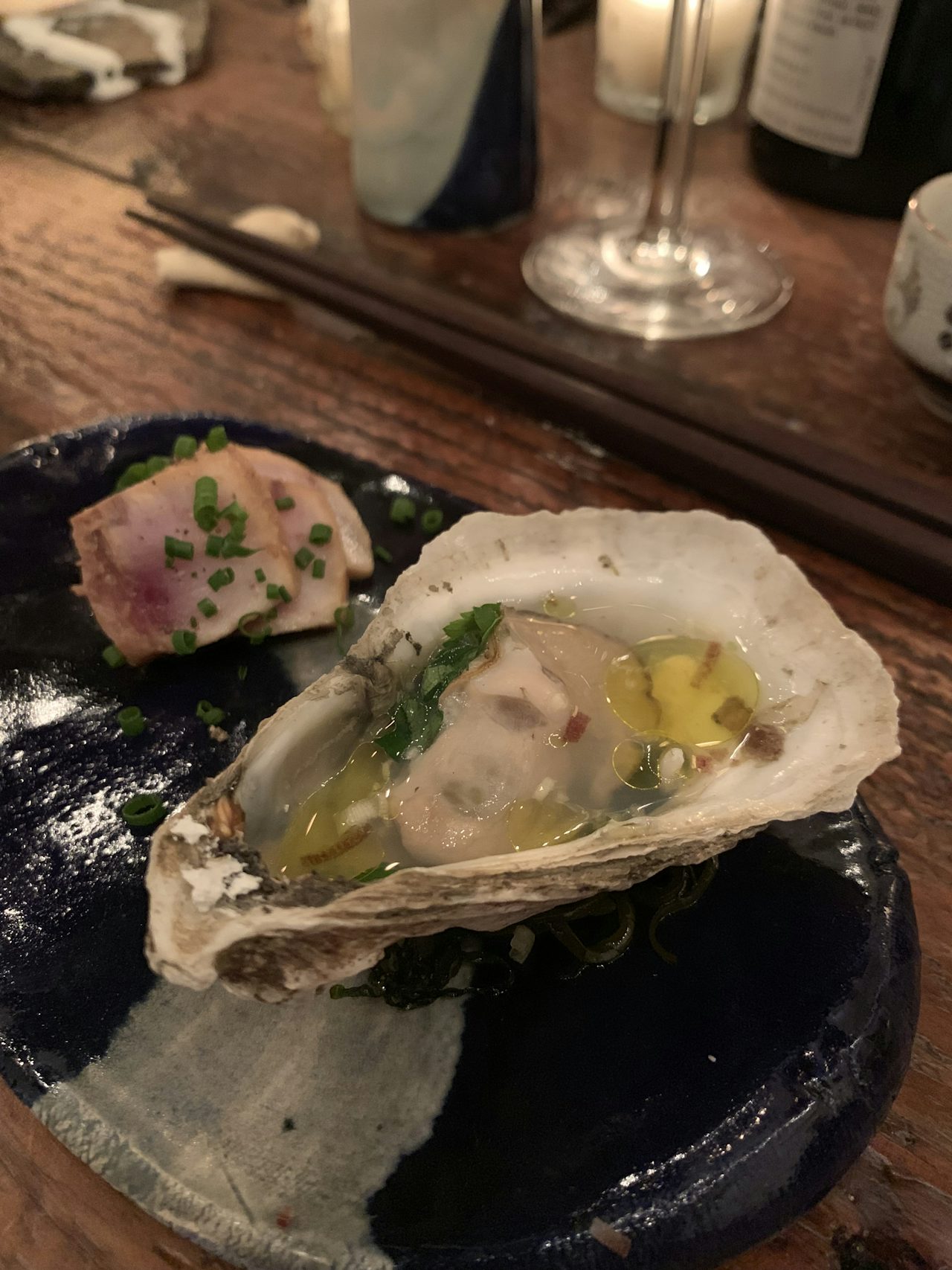 Fourth course featuring grilled oyster and marinated swordfish