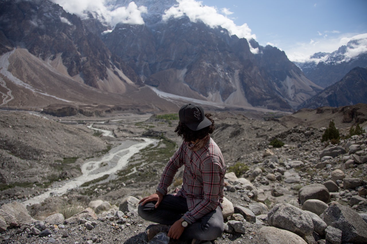 Passu resident Junaid Akhter looks over land that used to be the Batura Glacier, which previously extended to the river in the bottom right.