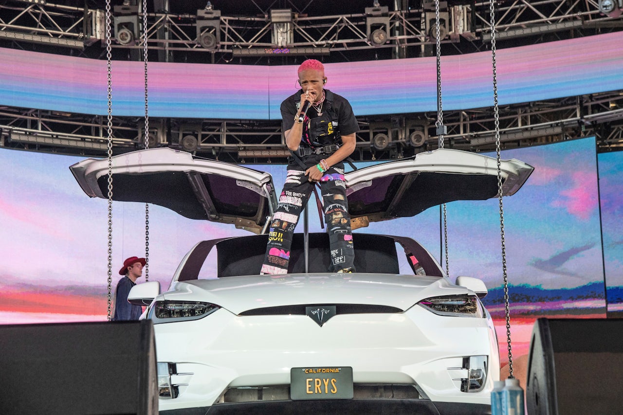 Jaden Smith performing on top of a Tesla Model X.